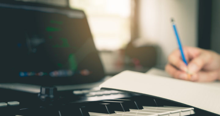 Songwriter, music paper and keyboard